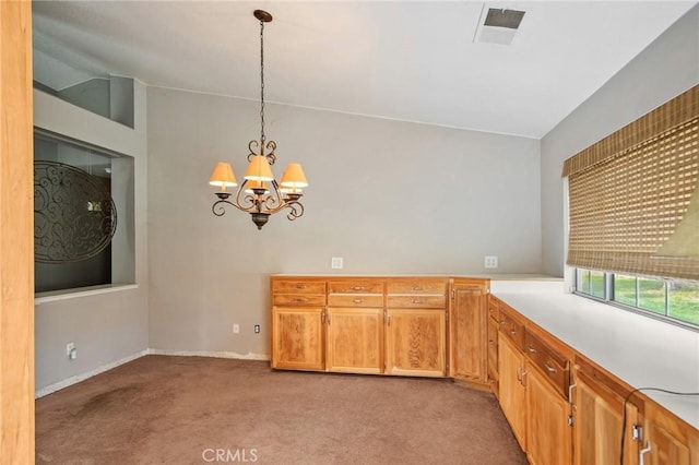 kitchen featuring pendant lighting, vaulted ceiling, an inviting chandelier, and light carpet