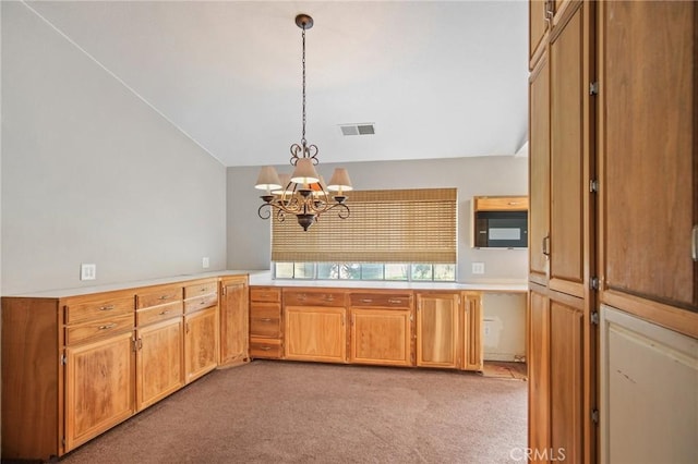 kitchen featuring vaulted ceiling, pendant lighting, light colored carpet, and a chandelier