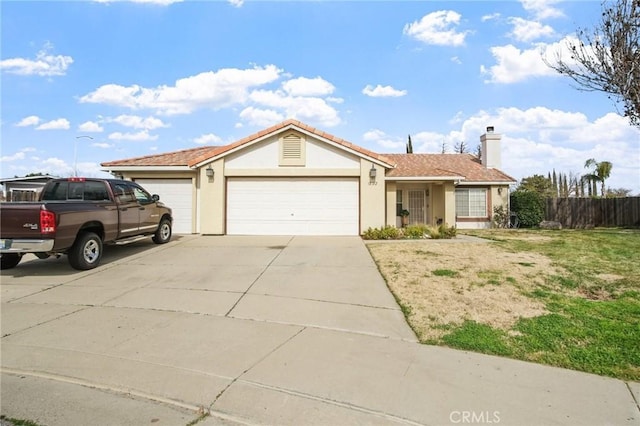 single story home featuring concrete driveway, an attached garage, fence, a front lawn, and stucco siding