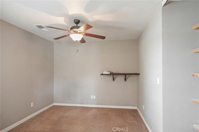 carpeted spare room featuring ceiling fan