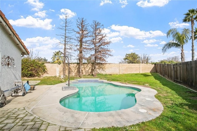 view of swimming pool with a yard and a patio