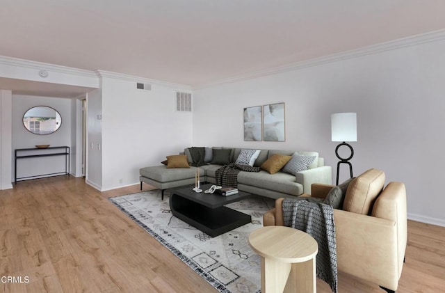 living room featuring crown molding and light hardwood / wood-style flooring