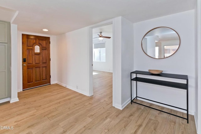 entrance foyer with ceiling fan and light hardwood / wood-style flooring