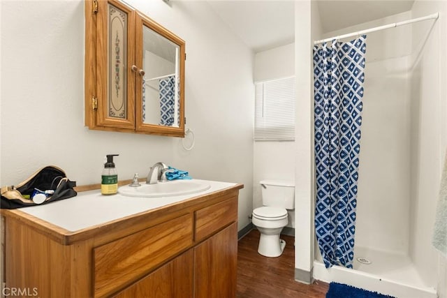 bathroom with walk in shower, vanity, toilet, and wood-type flooring