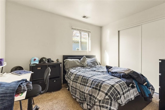 carpeted bedroom featuring a closet