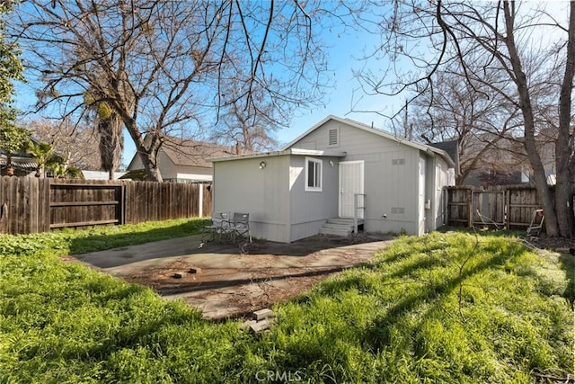 back of house featuring a yard and a patio