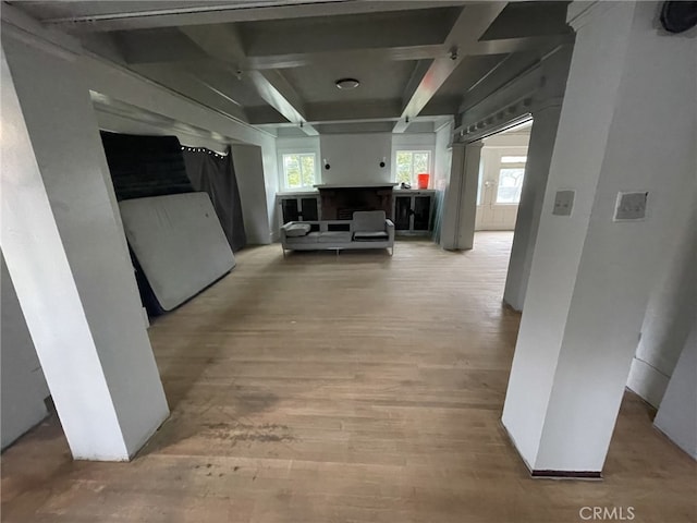 hallway with beamed ceiling, coffered ceiling, and wood finished floors