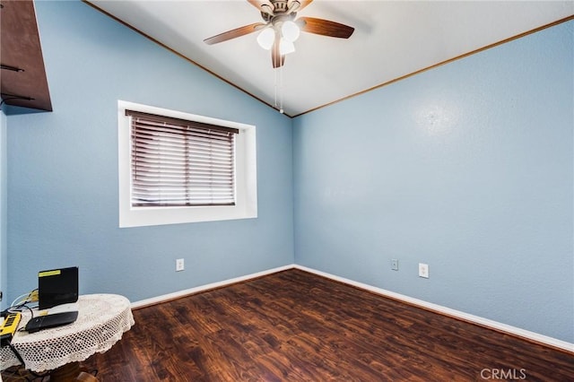 spare room featuring lofted ceiling, a ceiling fan, baseboards, and wood finished floors