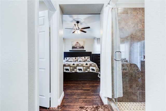 hall with a textured wall and wood finished floors