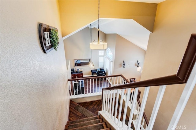 stairway with lofted ceiling and wood finished floors