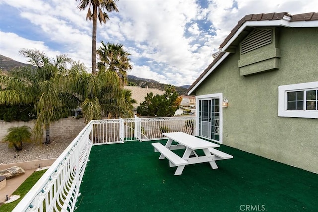 view of yard with a balcony and a mountain view