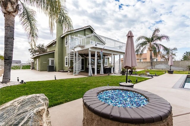 rear view of property with central AC, fence, a yard, stairway, and a patio area