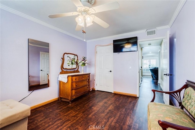 sitting room featuring wood finished floors, a ceiling fan, visible vents, baseboards, and ornamental molding