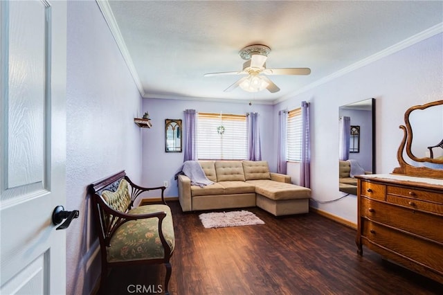 living area with ornamental molding, dark wood-style flooring, ceiling fan, and baseboards