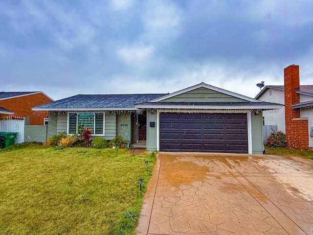 ranch-style home featuring a garage and a front lawn