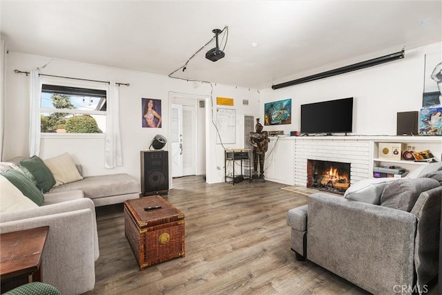 living room with hardwood / wood-style floors and a brick fireplace