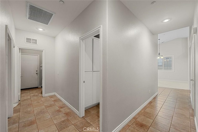 corridor featuring baseboards, visible vents, and recessed lighting