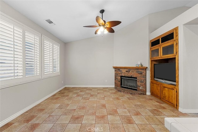 unfurnished living room with baseboards, visible vents, a ceiling fan, lofted ceiling, and a fireplace