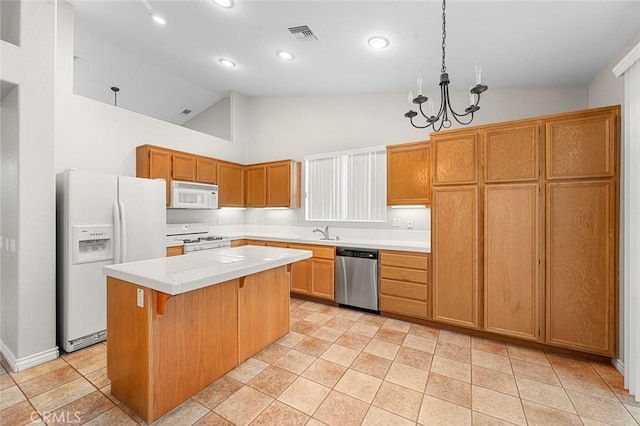 kitchen with light countertops, hanging light fixtures, a kitchen island, white appliances, and a kitchen bar