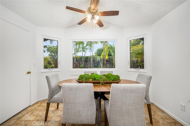 dining space with ceiling fan and a textured ceiling