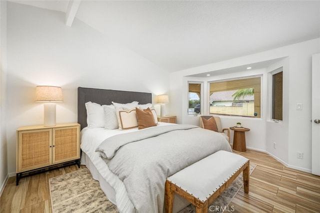 bedroom with hardwood / wood-style flooring and lofted ceiling with beams