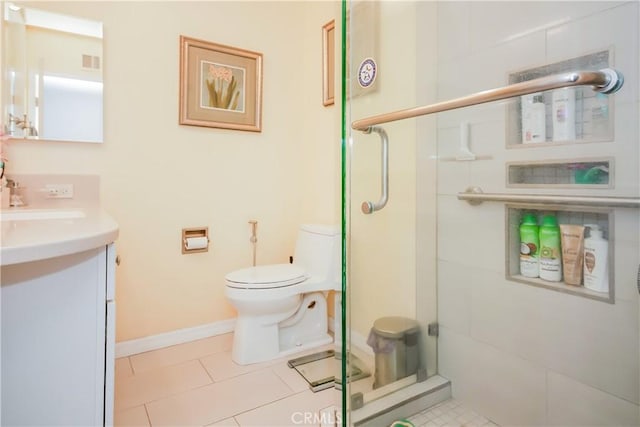 bathroom with vanity, a shower with shower door, tile patterned floors, and toilet