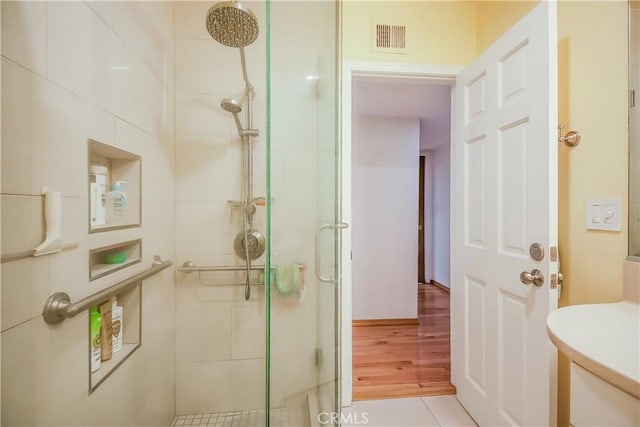 bathroom featuring an enclosed shower and toilet