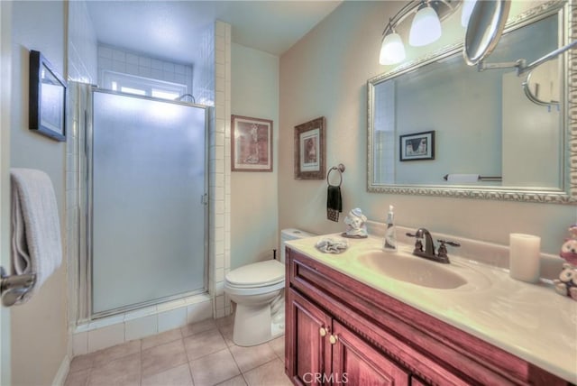 bathroom featuring vanity, tile patterned floors, toilet, and walk in shower