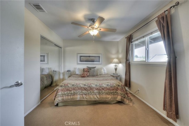 bedroom with ceiling fan, a closet, and carpet