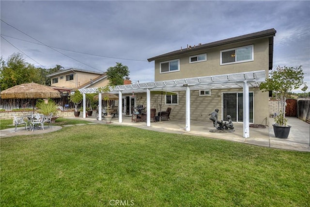 back of property with a yard, a patio area, and a pergola