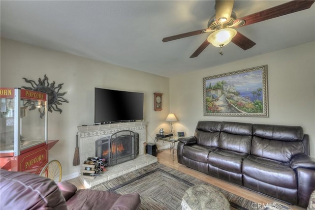 living room featuring ceiling fan and hardwood / wood-style floors