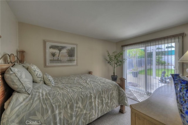 carpeted bedroom with access to outside