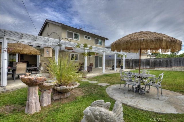 rear view of house featuring a lawn, a patio area, and a pergola