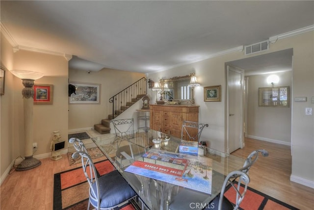 dining room featuring hardwood / wood-style flooring and ornamental molding