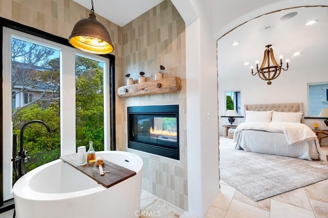 bedroom with a tiled fireplace and tile walls