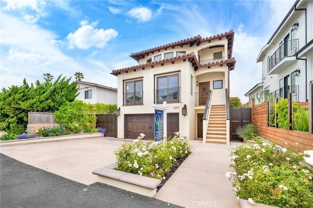 mediterranean / spanish-style house with a garage and a balcony