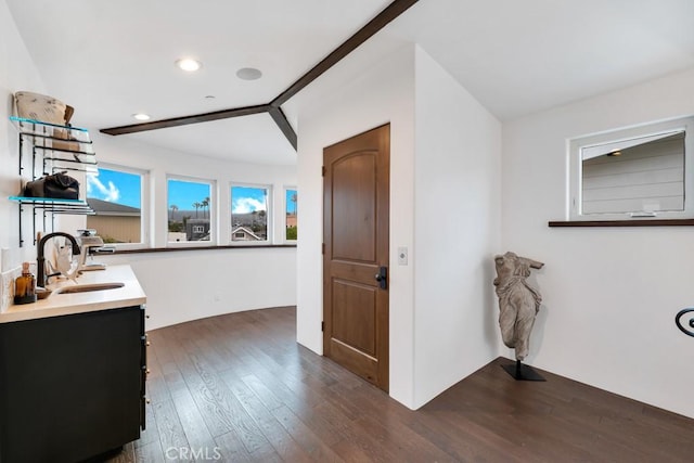 bathroom with hardwood / wood-style flooring, lofted ceiling, and sink