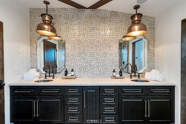 bar with sink, hanging light fixtures, and vaulted ceiling with beams