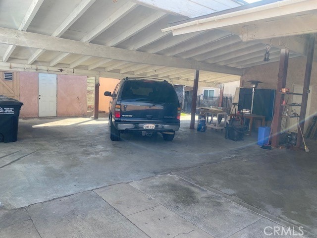 view of vehicle parking with a carport