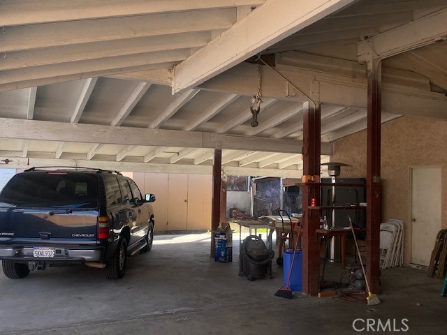 view of vehicle parking with a carport