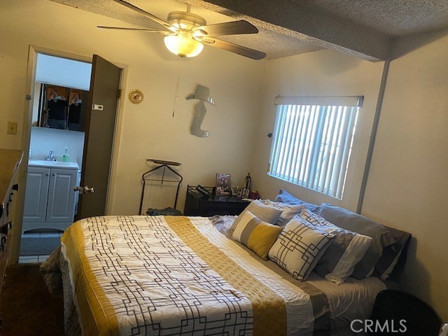 bedroom featuring sink, a textured ceiling, and ceiling fan