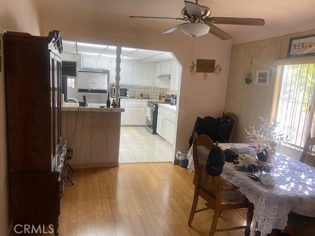 dining room featuring ceiling fan and light wood-type flooring