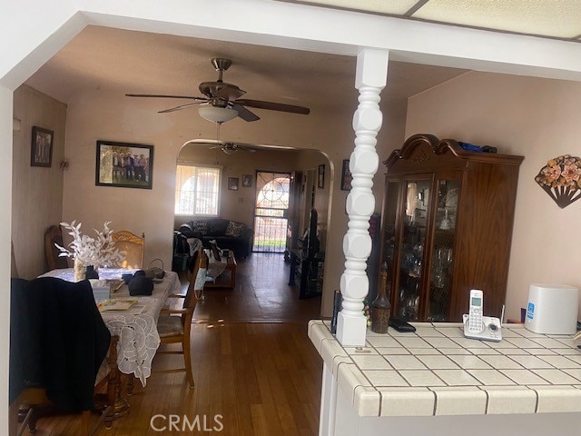 dining room with hardwood / wood-style floors and ceiling fan