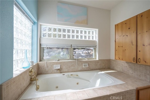 full bath featuring a whirlpool tub and plenty of natural light