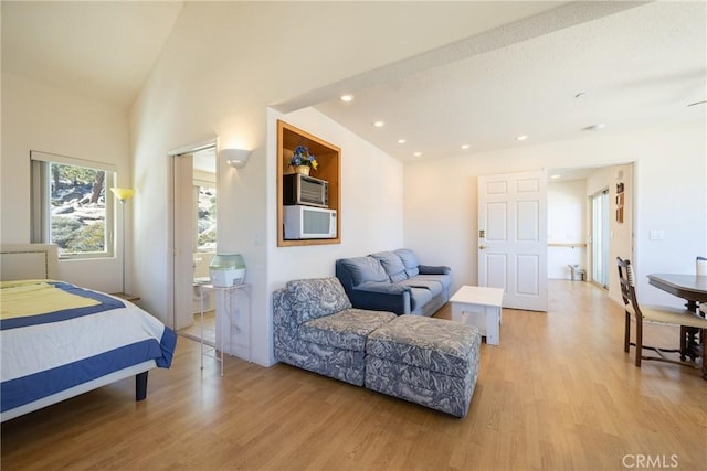 bedroom with recessed lighting, light wood-style floors, and vaulted ceiling