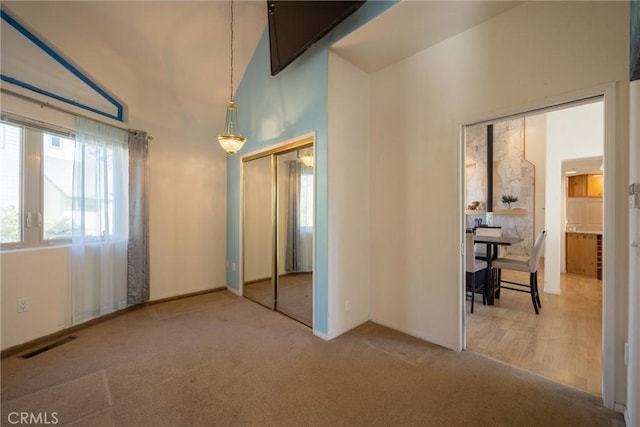 carpeted bedroom featuring visible vents, baseboards, and a closet