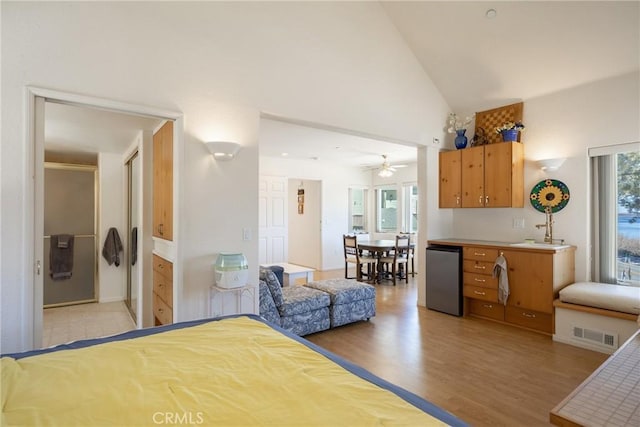 bedroom with visible vents, high vaulted ceiling, and light wood-type flooring