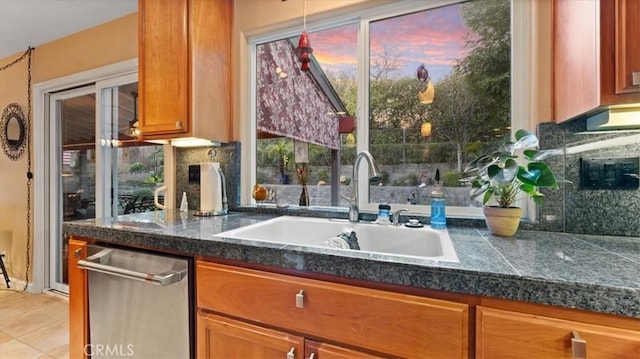 kitchen with dishwasher, sink, and backsplash