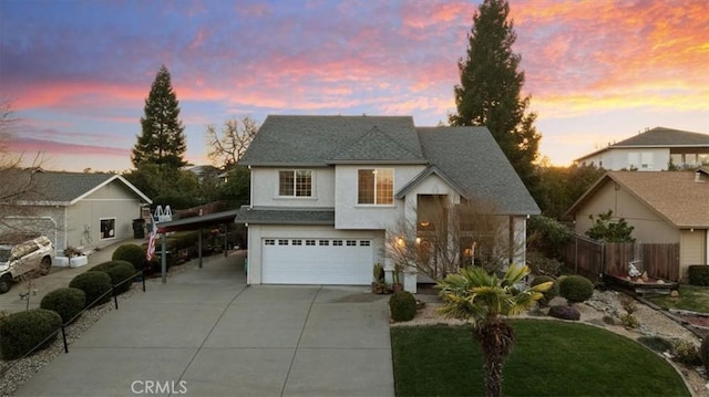 front facade with a garage and a carport