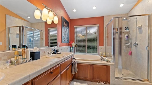 bathroom with vanity, separate shower and tub, and vaulted ceiling